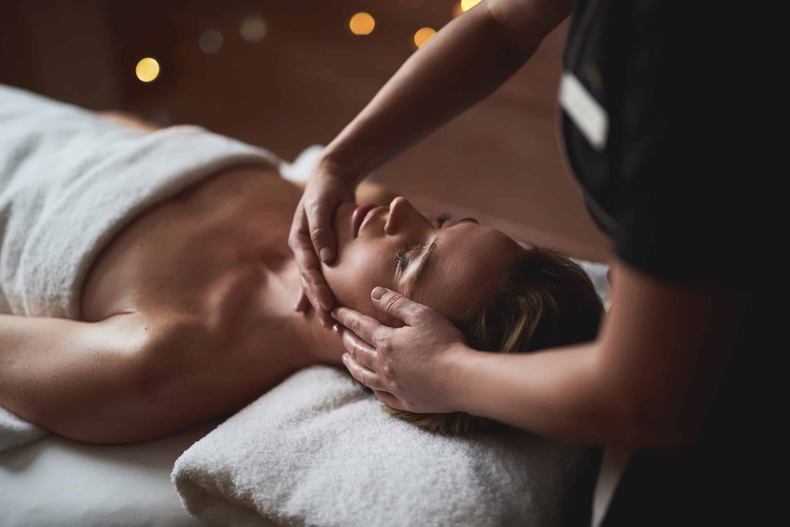 Young lady have anti age massage of face